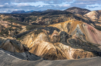 Scenic view of mountains against cloudy sky