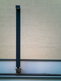 Close-up of metal pipe against wall
