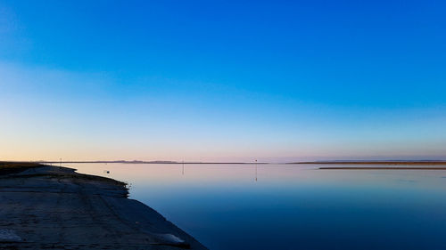 Scenic view of sea against clear blue sky