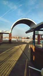 Empty railway bridge in city against sky