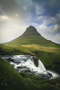 Scenic view of waterfall against sky