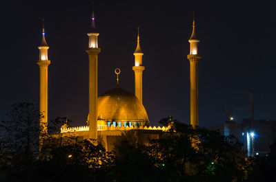 Illuminated national mosque of nigeria against sky at night