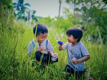 Children on field against plants