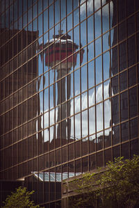 Low angle view of glass building against sky