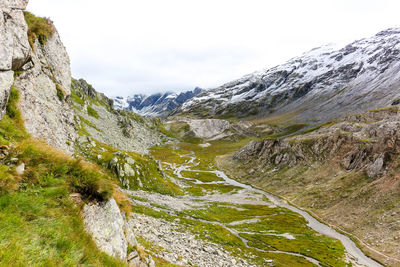 Greina high plateau with stream in swiss alps