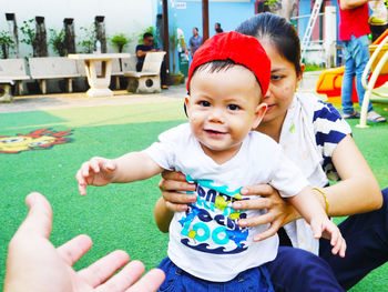 Mother and son sitting at playground