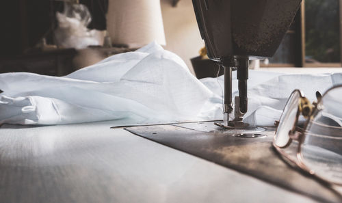 Close-up of white fabric on sewing machine