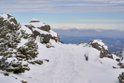 Scenic view of snow covered mountains against sky