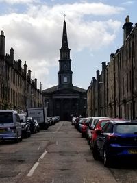 Cars on street amidst buildings in city