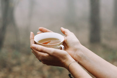 Cropped hand holding coffee