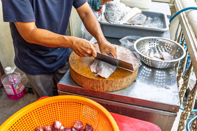 Midsection of man preparing food