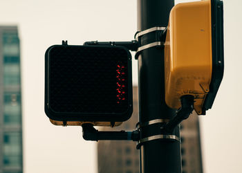 Close-up of telephone booth against buildings in city