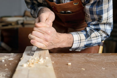 Midsection of man working on table