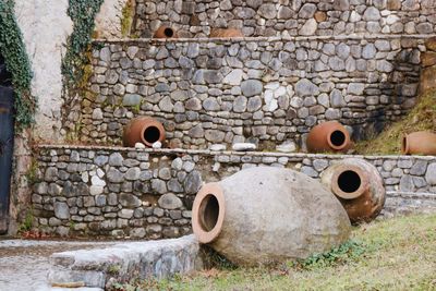 Earthenware against stone wall