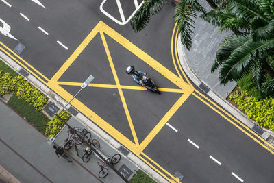 A small scooter driving along the empty road in singapore