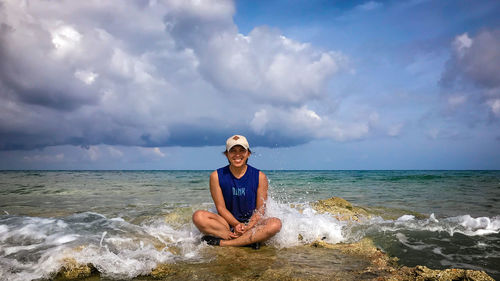 Portrait of man on sea shore against sky