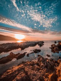Scenic view of sea against sky at sunset