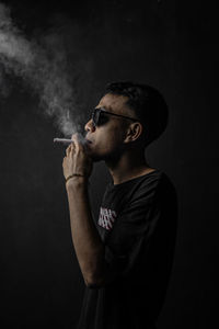 Young man smoking cigarette