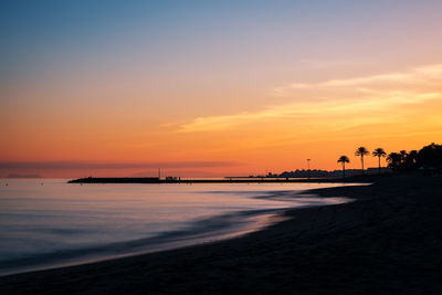 Scenic view of calm sea at sunset