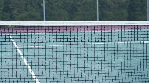 A close up shot of a tennis net in a tennis professional court. tennis sport background.