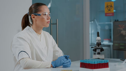 Scientist looking away in laboratory