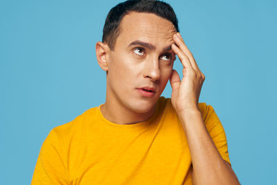 Man looking away against blue background