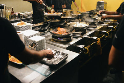 High angle view of people preparing food in kitchen