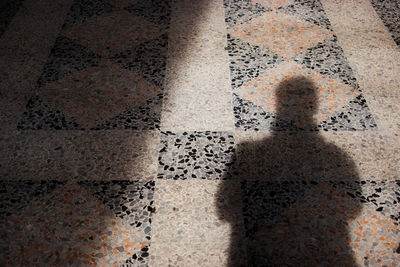High angle view of person shadow on street