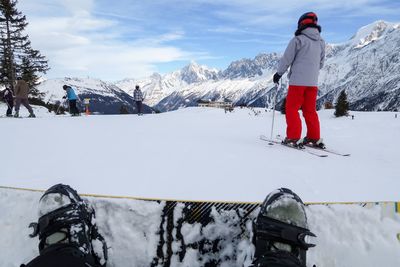 Rear view of woman skiing on snowcapped mountain