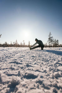 Winter outdoor sports for health promotion . a side view of a cute young athlete, in a snowy forest