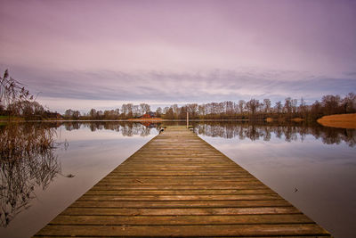 Pier over lake against sky