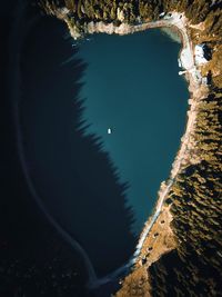 High angle view of trees by rocks against sky