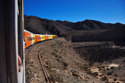 Train at railroad track against sky