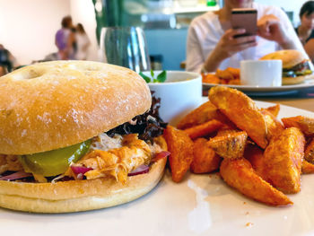 Close-up of burger with fried potato served in plate