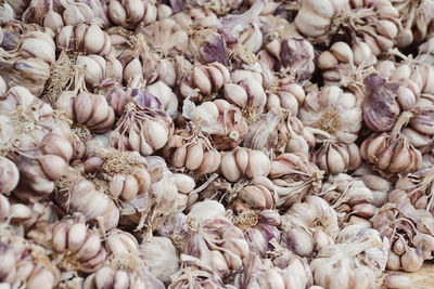 Full frame shot of garlic bulbs for sale in market