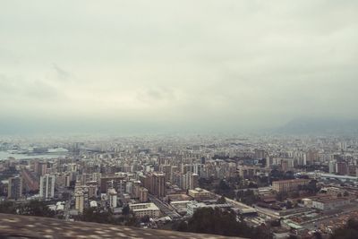 Cityscape against cloudy sky