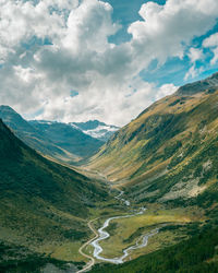 Scenic view of valley and mountains against sky