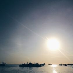 Boat sailing in sea at sunset