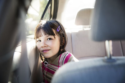 Girl looking away while traveling in car