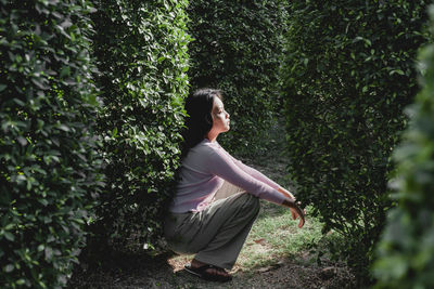 Side view of woman in forest