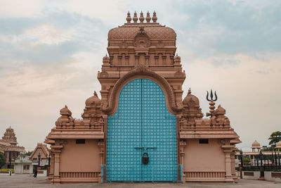 Statue of temple against cloudy sky