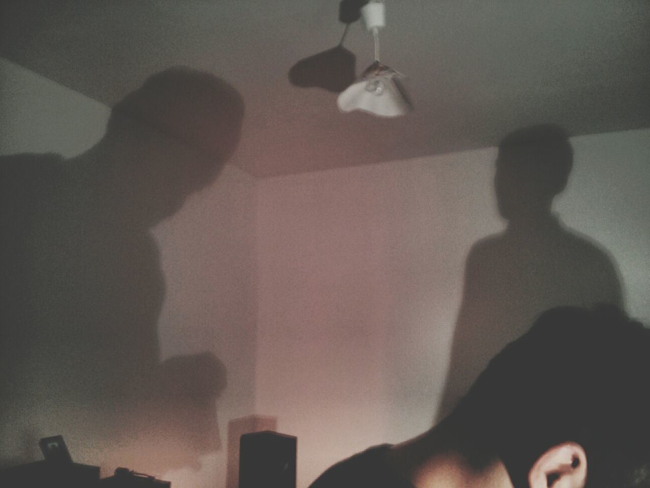 indoors, lifestyles, wall - building feature, leisure activity, men, home interior, person, illuminated, silhouette, standing, shadow, unrecognizable person, domestic room, lighting equipment, flooring