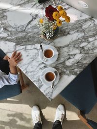 Low section of person with food on table