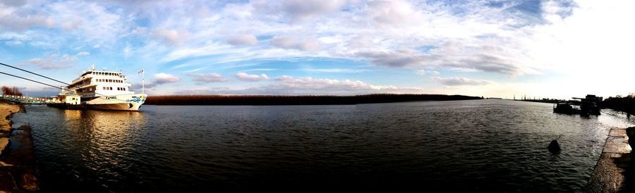 Scenic view of river against cloudy sky