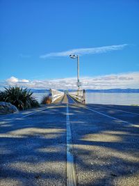Surface level of pier against blue sky