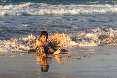 High angle view of child swimming in sea 