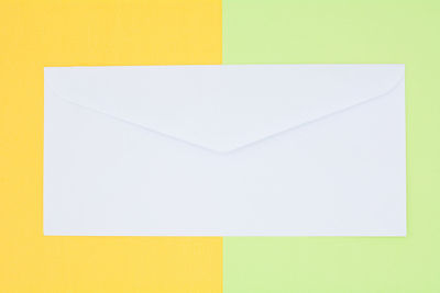 Directly above shot of yellow paper against white background