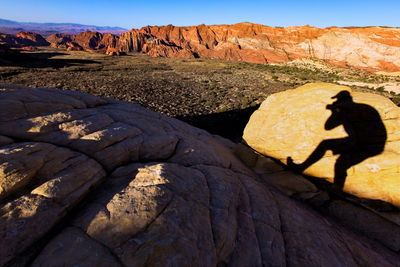 High angle view of man shadow on rock