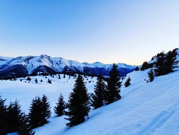 Scenic view of snow covered mountains against clear sky