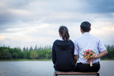 Rear view of couple against sky